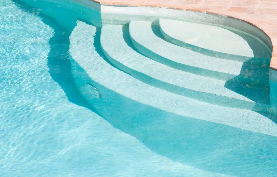 A swimming pool with stairs leading up to it
